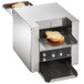 A Vollrath conveyor toaster with a sandwich with cheese on it being toasted.