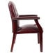 A Boss Ivy League burgundy vinyl executive guest chair with mahogany finish and gold studs on the arms.