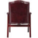 The back of a Boss Ivy League burgundy vinyl guest chair with mahogany finish.