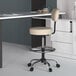 A beige Boss drafting stool with a metal base.