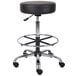 A black Boss drafting stool with chrome legs and wheels.