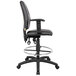 A Boss black leather drafting stool with adjustable arms.
