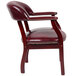 A burgundy vinyl Boss Captain's Chair with gold studs.