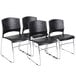 A group of four Boss black plastic stack chairs with chrome legs.