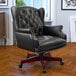 A Boss black leather wingback office chair.