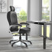 A Boss black pillow top executive chair with a chrome base and wheels at a black desk.