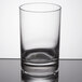 A Stolzle New York juice glass on a table with a white background.