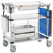 A Metro PrepMate MultiStation with stainless steel shelving and trays on wheels.