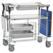 A Metro stainless steel kitchen cart with trays on it.