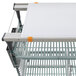 A metal cart with a white shelf and white accessories on top.