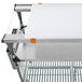 A Metro PrepMate MultiStation with a stainless steel tray and white cutting board on a cart.