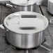 A Vollrath stainless steel pot cover on a pot.