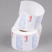 A Globe E12 label roll with red and white labels on a roll of paper.