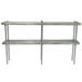 A stainless steel table mounted double deck shelving unit with metal rods.