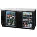 A black Beverage-Air back bar refrigerator with glass doors full of bottles.