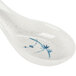 A white Chinese soup spoon with a blue bamboo design on the handle.