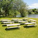 A pack of white Lifetime rectangular picnic tables with attached benches on grass.