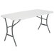 A white rectangular Lifetime fold-in-half table with metal legs.