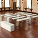 A group of white Lifetime seminar tables.