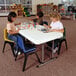 Children sitting at a Lifetime plastic folding table painting.