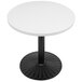 An Art Marble Furniture white quartz table top on a white table with a black base.