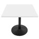 A white rectangular Art Marble Furniture table top with black border on a black metal table base.