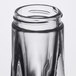 A close-up of a clear glass Libbey salt and pepper shaker with a black rim.