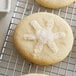 Clear white sanding sugar on a snowflake sugar cookie.