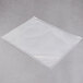 An ARY VacMaster clear plastic vacuum packaging bag on a grey surface.