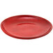 A red porcelain plate with a small rim and speckled surface.