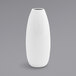 A close up of a Front of the House white porcelain bud vase with a white spiral design.