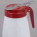 A Tablecraft white polypropylene syrup dispenser with a red lid.