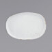 A white oval porcelain plate with brown specks.