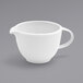 A white porcelain creamer pitcher with a handle.