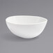 A Front of the House white porcelain bowl with a small rim on a gray background.