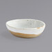 A white Front of the House Artefact ramekin with speckled brown edges.