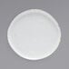 A white porcelain plate with brown specks.