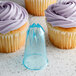 A cupcake with purple frosting piped using an Ateco plastic closed star piping tip.