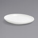 A white Front of the House porcelain plate with a small rim on a gray surface.