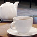 A close-up of a white Front of the House Spiral porcelain cup on a table.