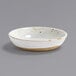 A white Front of the House round porcelain ramekin with brown specks.