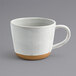 A white Front of the House Artefact mug with a brown handle.