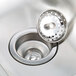 A close-up of a stainless steel Advance Tabco hand sink with a drain.