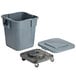 A Rubbermaid gray plastic square trash can with a lid and wheel.