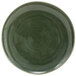 A green porcelain plate with a circular pattern on the rim.