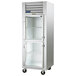 A white Traulsen G Series reach-in refrigerator with glass half doors.