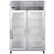 A stainless steel Traulsen G Series reach-in refrigerator with two glass doors and shelves.