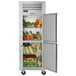 A silver Traulsen G Series reach-in refrigerator with right hinged doors open and full of food.
