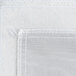 A close up of a white fabric with a stitched edge.