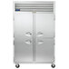 A Traulsen G Series reach-in refrigerator with white half doors and handles.